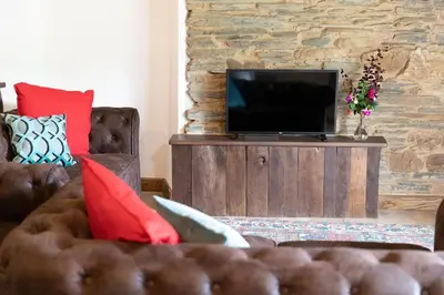 a living room with a couch and a flat screen tv at Casa Liñeiras in Lugo