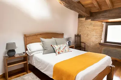 a bedroom with a large bed with a yellow blanket at Casa Liñeiras in Lugo