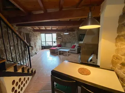 a living room with a table and a couch at Casa Amil da Vilaboa, Allariz in Allariz