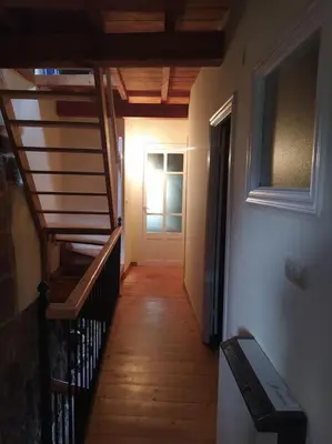 a hallway with stairs and a door in a house at Casa Amil da Vilaboa, Allariz in Allariz