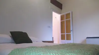 a bedroom with a bed and an open door at Casa Amil da Vilaboa, Allariz in Allariz