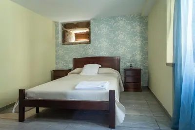 a bedroom with a bed and a blue wall at CASA DO LEAL SILVER WAY in Silleda