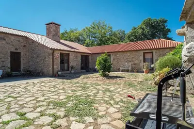 a house with a stone yard in front of it at CASA DO LEAL SILVER WAY in Silleda