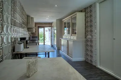 a kitchen with a table and a counter top at CASA DO LEAL SILVER WAY in Silleda