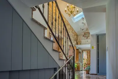 a hallway with a staircase with wooden railings at CASA DO LEAL SILVER WAY in Silleda