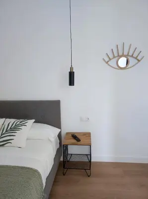 a bedroom with a bed and a table with a lamp at Cabañas Alcobas do Sil Ecoturismo in Parada del Sil