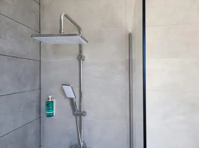 a shower with a shower head in a bathroom at Cabañas Alcobas do Sil Ecoturismo in Parada del Sil