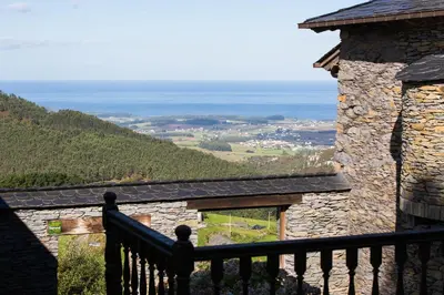 a balcony of a stone building with a view at El Vallín de Alba in La Artosa