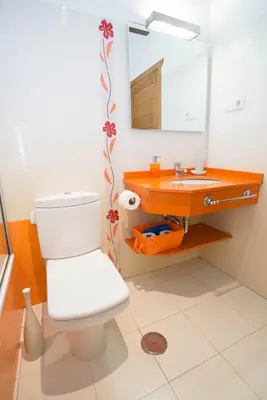 a bathroom with a white toilet and a sink at El Vallín de Alba in La Artosa