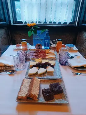 a table with a bunch of different types of bread at Pazo de Bendoiro in Bendoiro