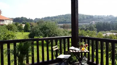 a balcony with a table and a view of a field at Pazo de Bendoiro in Bendoiro