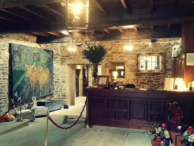 a room with a large painting on a stone wall at Pazo de Bendoiro in Bendoiro