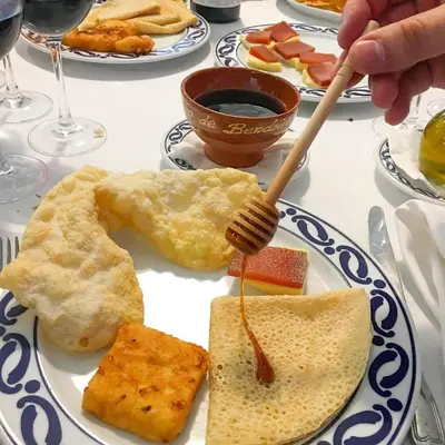 a plate of breakfast food with a fork and eggs at Pazo de Bendoiro in Bendoiro