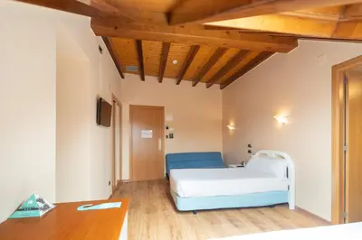 a bedroom with a bed and a desk in a room at Hotel Alda Lalín in Lalín