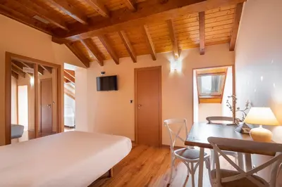 a bedroom with a bed and a desk and a table at Hotel Alda Lalín in Lalín