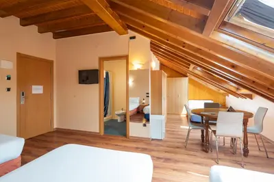 a room with a bed and a table and chairs at Hotel Alda Lalín in Lalín