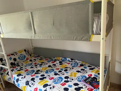 a bunk bed with a hello kitty blanket on it at Carballo Alenza,2 in Castro Caldelas
