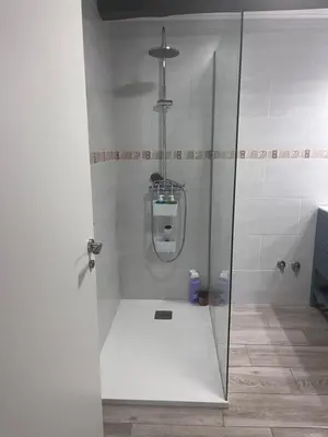 a shower with a glass door in a bathroom at Carballo Alenza,2 in Castro Caldelas