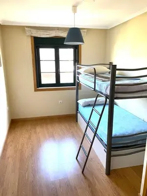 a room with two bunk beds and a window at Barreiros Playa Altar in Barreiros