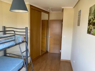 a small room with a bunk bed and a hallway at Barreiros Playa Altar in Barreiros