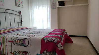a bedroom with a bed with a colorful blanket at Amplio piso en Pontedeume in Puentedeume