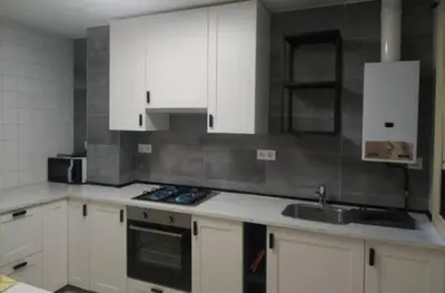 a kitchen with white cabinets and a sink at Amplio piso en Pontedeume in Puentedeume