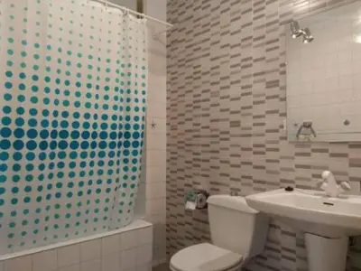 a bathroom with a toilet and a sink and a shower at Amplio piso en Pontedeume in Puentedeume