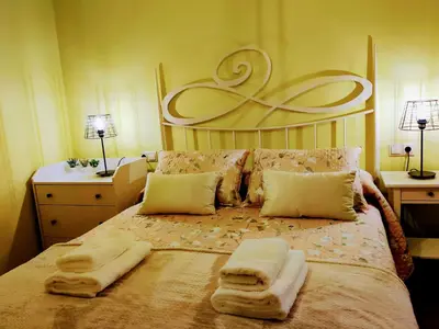 a bedroom with a large bed with towels on it at Alojamiento Real Monforte de Lemos in Monforte de Lemos