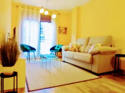 a living room with a couch and a table at Alojamiento Real Monforte de Lemos in Monforte de Lemos