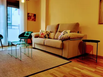 a living room with a couch and two tables at Alojamiento Real Monforte de Lemos in Monforte de Lemos