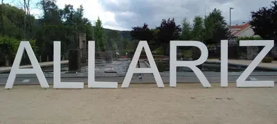 a large white sign sitting in the middle of a park at Casa MENDEZ - ALLARIZ in Ourense