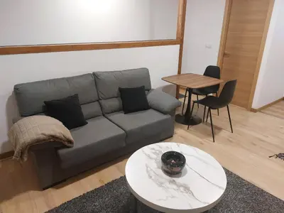 a living room with a couch and a table at Casa MENDEZ - ALLARIZ in Ourense