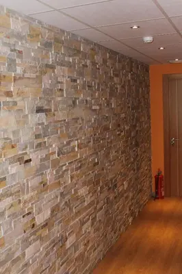 an empty room with a brick wall at Hostal Burbia in Villafranca del Bierzo
