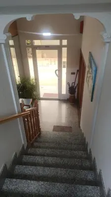 a stairway leading to a hallway with a door at Hostal Burbia in Villafranca del Bierzo