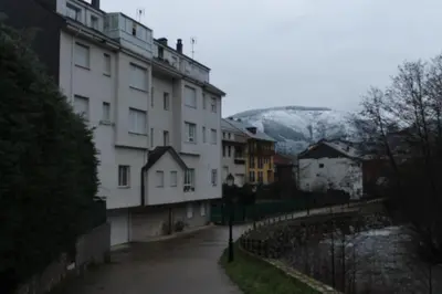 a view of a building with mountains in the background at Hostal Burbia in Villafranca del Bierzo