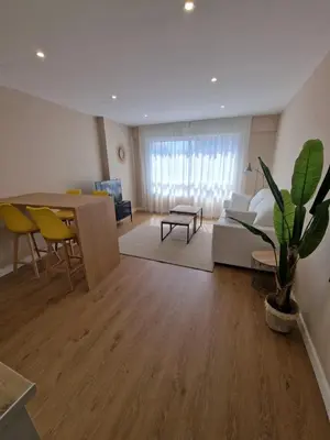 a living room with a couch and a table at Apartamentos Turísticos MENCÍA in Monforte de Lemos