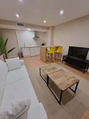 a living room with a couch and a table and a piano at Apartamentos Turísticos MENCÍA in Monforte de Lemos