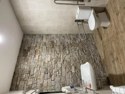 a bathroom with two sinks and a tiled floor at Albergue a Carballeira in Villalba