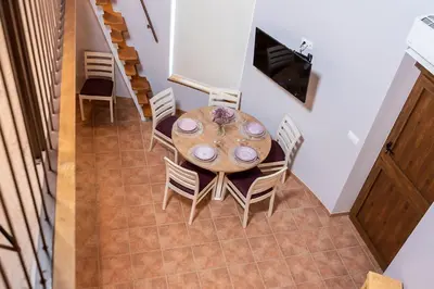 a dining room with a table and chairs at Pallozas Turísticas Ridicodias - A Vieira in Laza