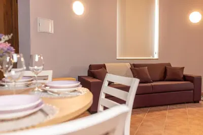a living room with a table and a couch at Pallozas Turísticas Ridicodias - A Vieira in Laza