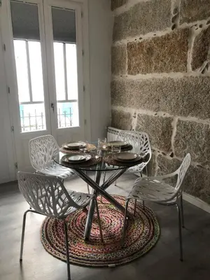 a dining room with a table and chairs at A esmorga in Ourense