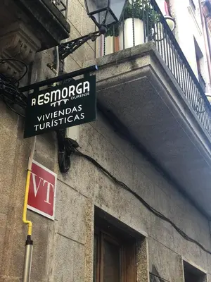 a street sign on the side of a building at A esmorga in Ourense