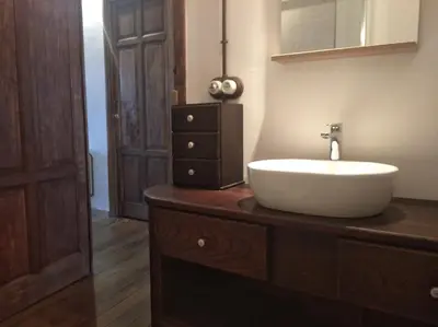 a bathroom with a white sink on a wooden dresser at Vivienda A Travesía Dos Soños in Sarria