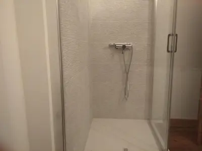 a shower with a glass door in a bathroom at Vivienda A Travesía Dos Soños in Sarria