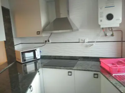 a kitchen with a microwave and a counter top at Vivienda A Travesía Dos Soños in Sarria