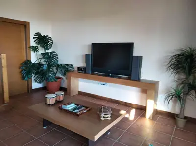 a living room with a tv and a coffee table at Lobetios - Casa rural in Parada de Achas
