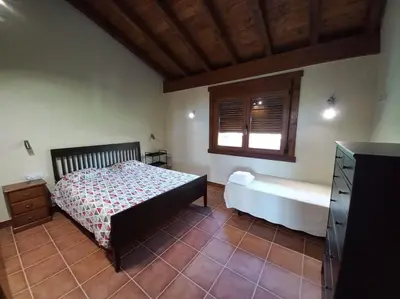 a bedroom with a bed and a window at Lobetios - Casa rural in Parada de Achas