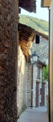 a row of houses with balconies on a street at Casa Rural Maria in Molinaseca