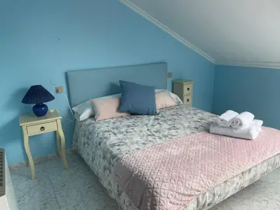 a bedroom with a bed with towels on it at Apartamento con hermosas vistas a la playa del Altar in Sieiro
