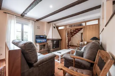 a living room with two couches and a fireplace at Exclusiva Casa Rural Mariano con acceso directo al rio in Baralla